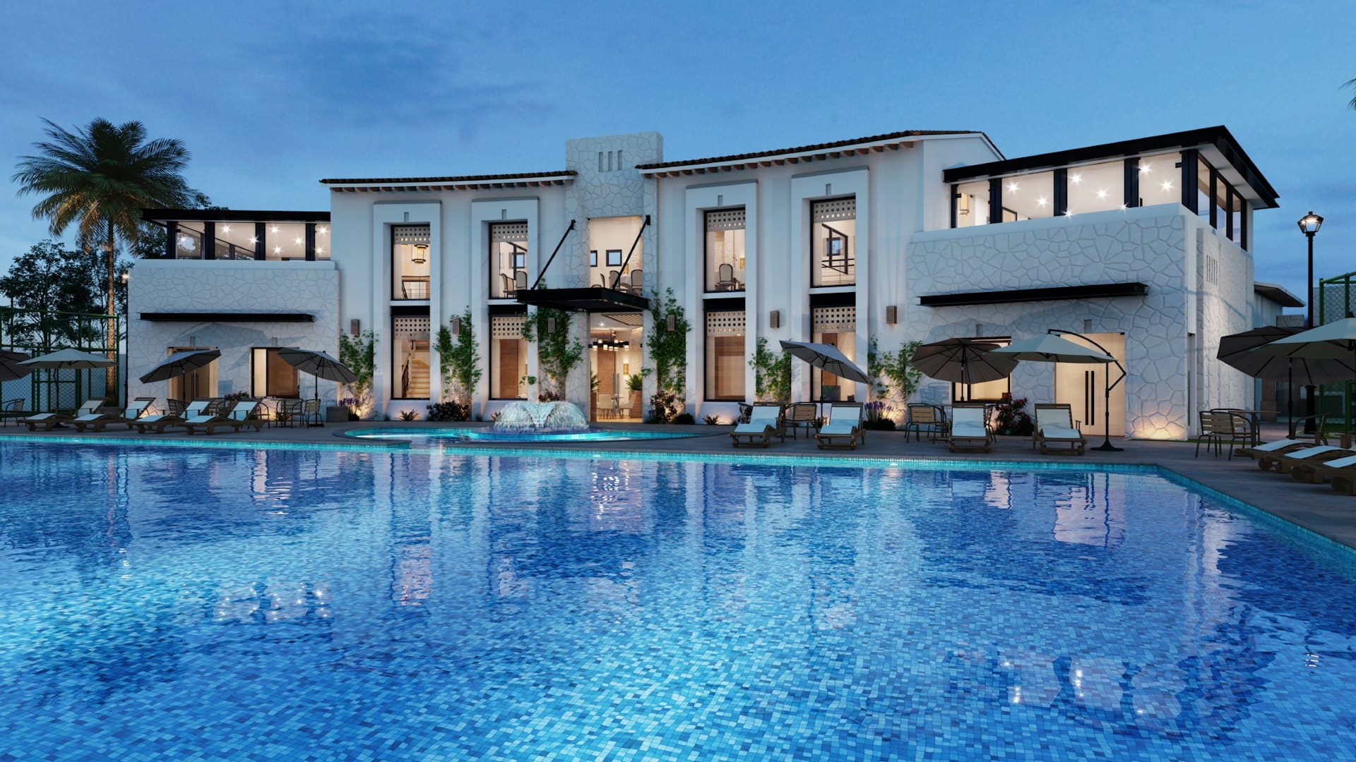 Hotel courtyard and pool deck lit at dusk