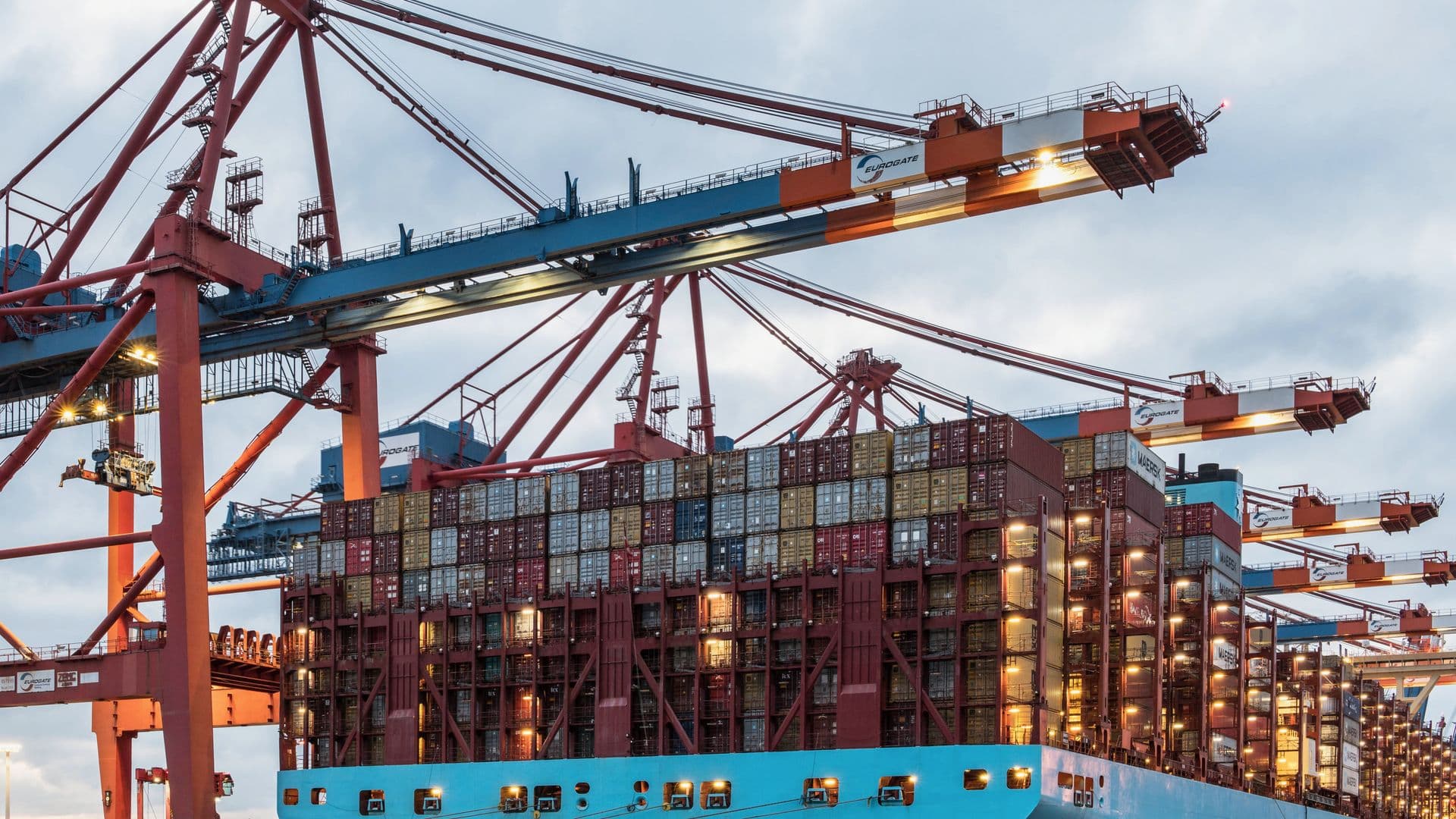 Gantry cranes loading a container ship at a working berth