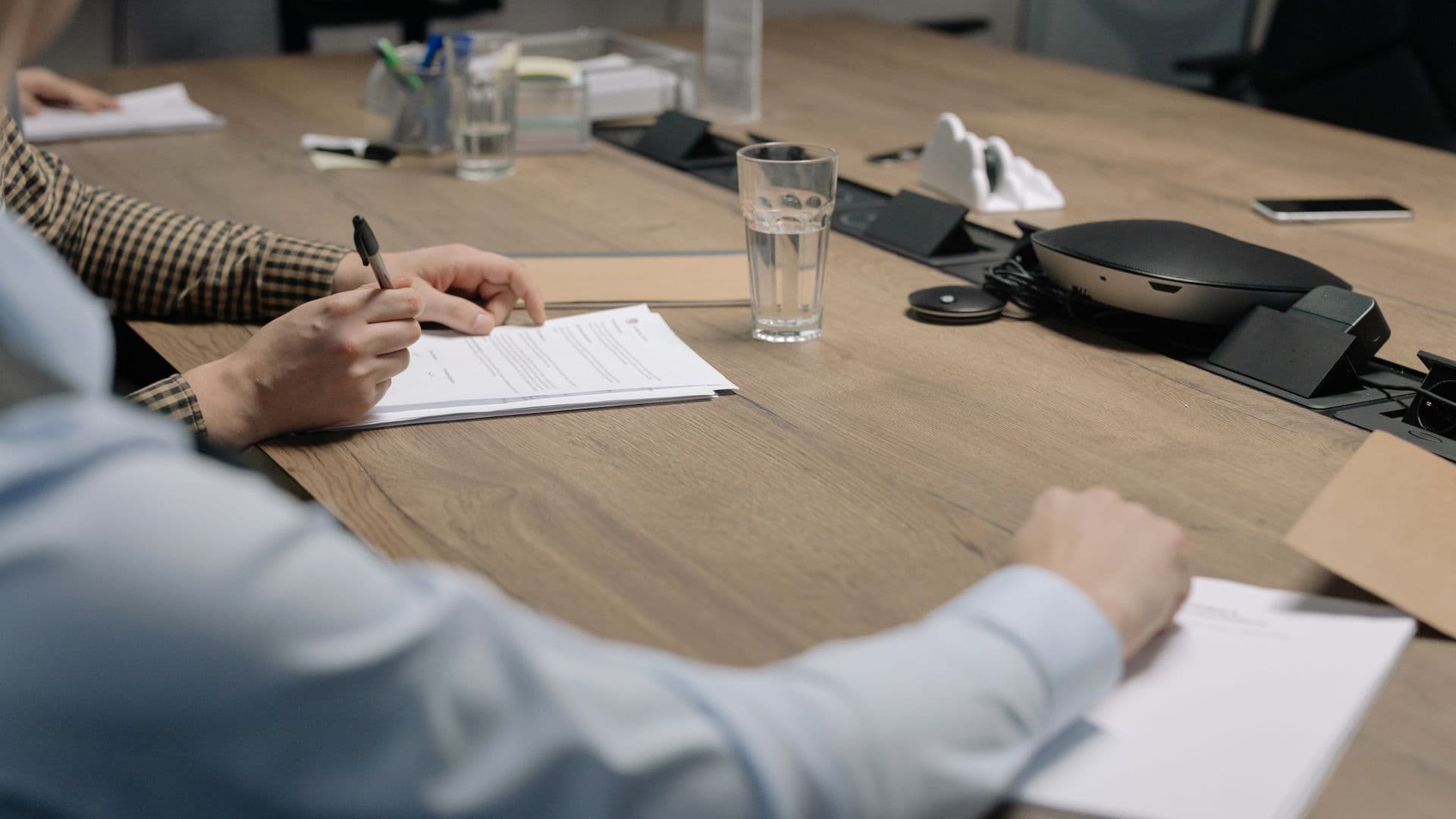 Advisers working through documents around a boardroom table